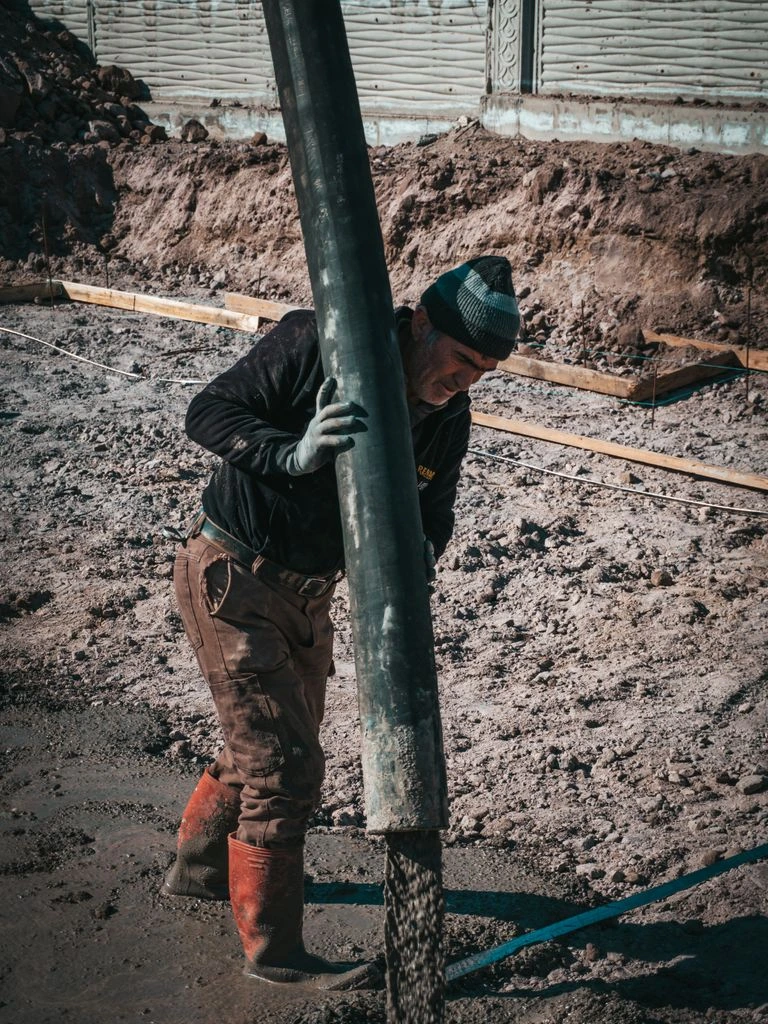Winter concrete pour under heated tarpaulin enclosure at a Hokkaido bridge site
